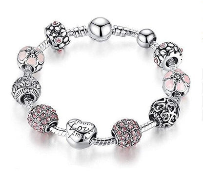 Silver-tone charm bracelet with pink sparkle beads and heart Love charm.