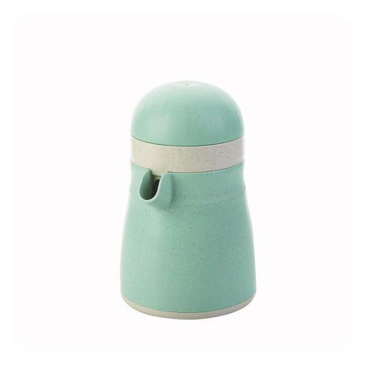 Light green manual citrus juicer with press lid, strainer, and pour spout