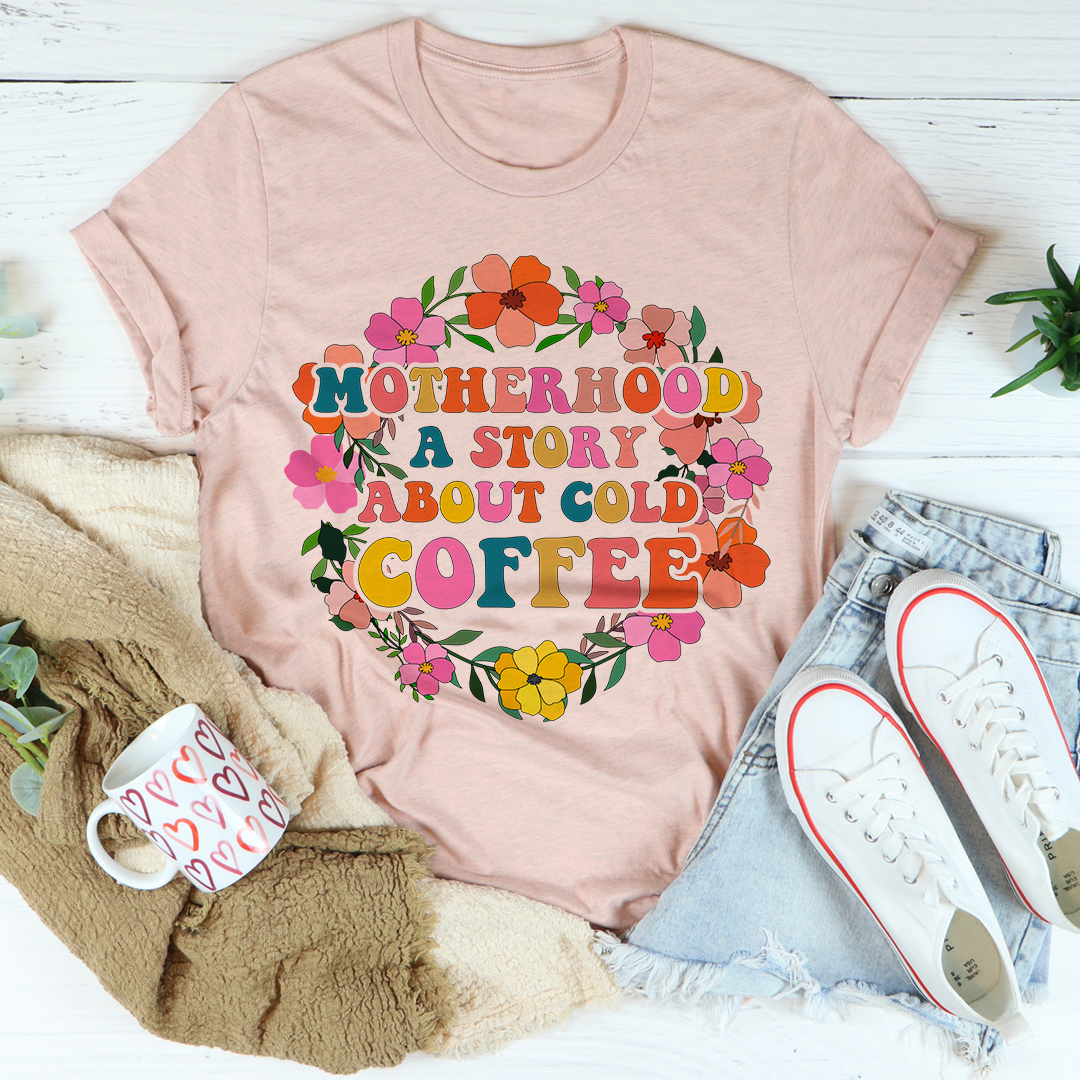 Peach T-shirt with colorful floral 'MOTHERHOOD' and 'COLD COFFEE' text heart graphic