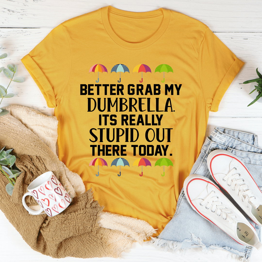 Gold crew-neck T-shirt with umbrella graphic and bold black slogan text