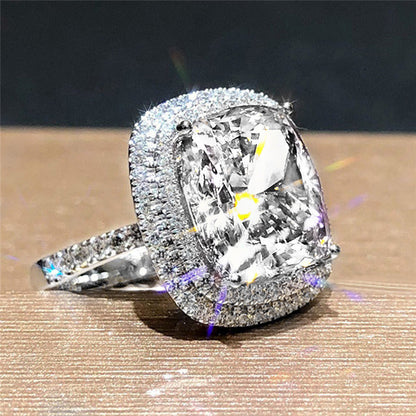 Rhinestone bridal ring with clear faceted cushion center stone and silver pavé halo