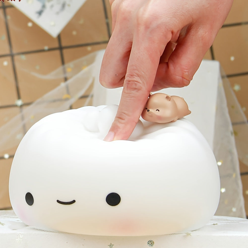 White silicone dumpling night light with pig figurine as a hand touches the top