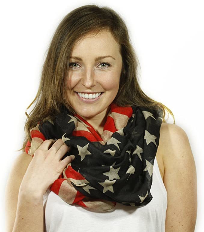 Infinity scarf in black, red, and cream with stars and striped pattern, looped around neck