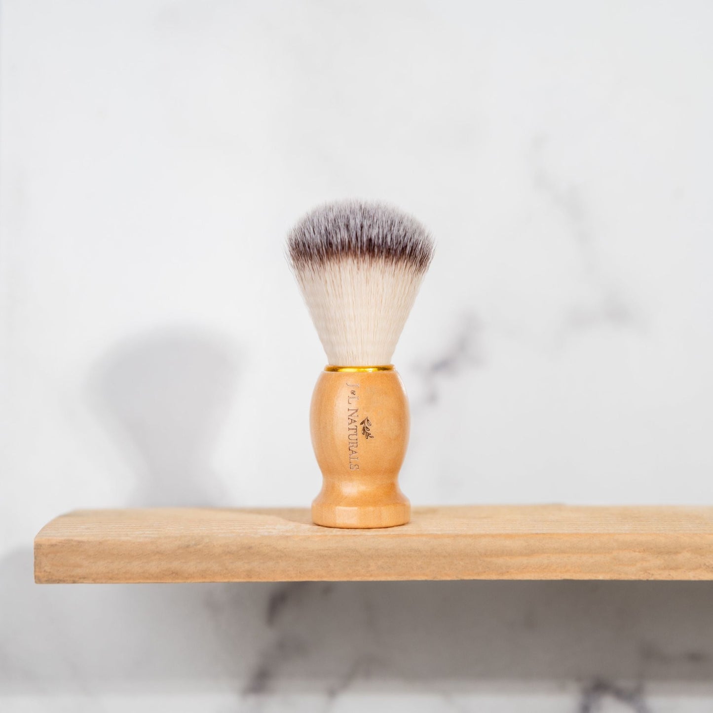 Shave brush with dense bristles and light wood handle