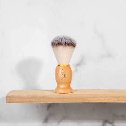 Shave brush with dense bristles and light wood handle