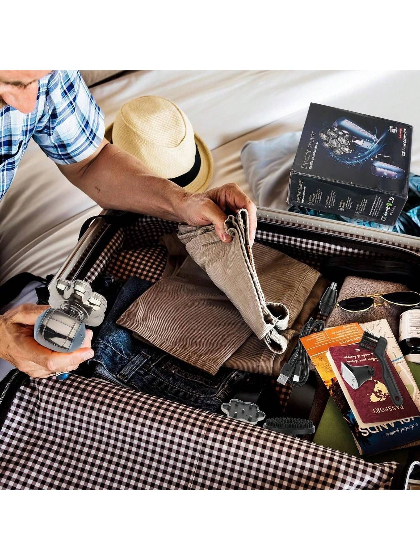Electric shaver kit with attachments on clothes inside a suitcase