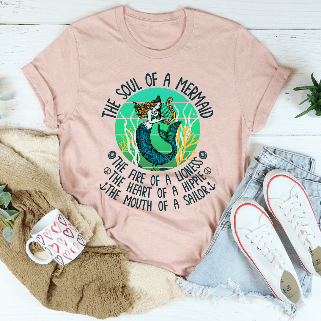 Soft pink mermaid graphic t-shirt with circular text and teal tail illustration