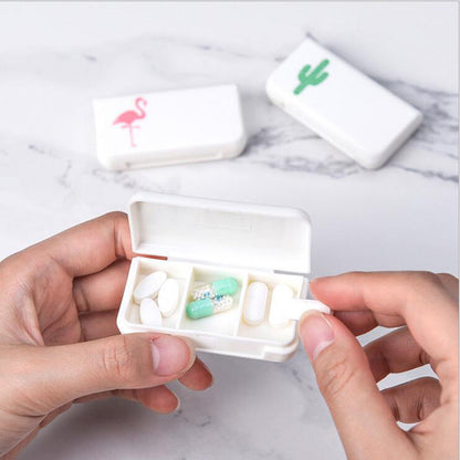 White pill organizer case with 3 compartments, held open showing tablets and capsules