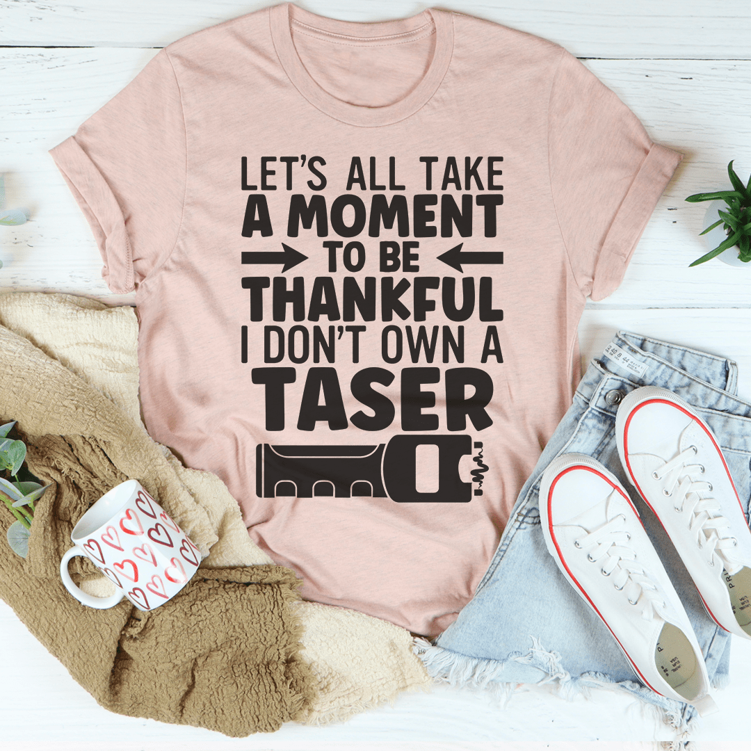 Peach-pink crewneck T-shirt with bold black quote graphic on the front