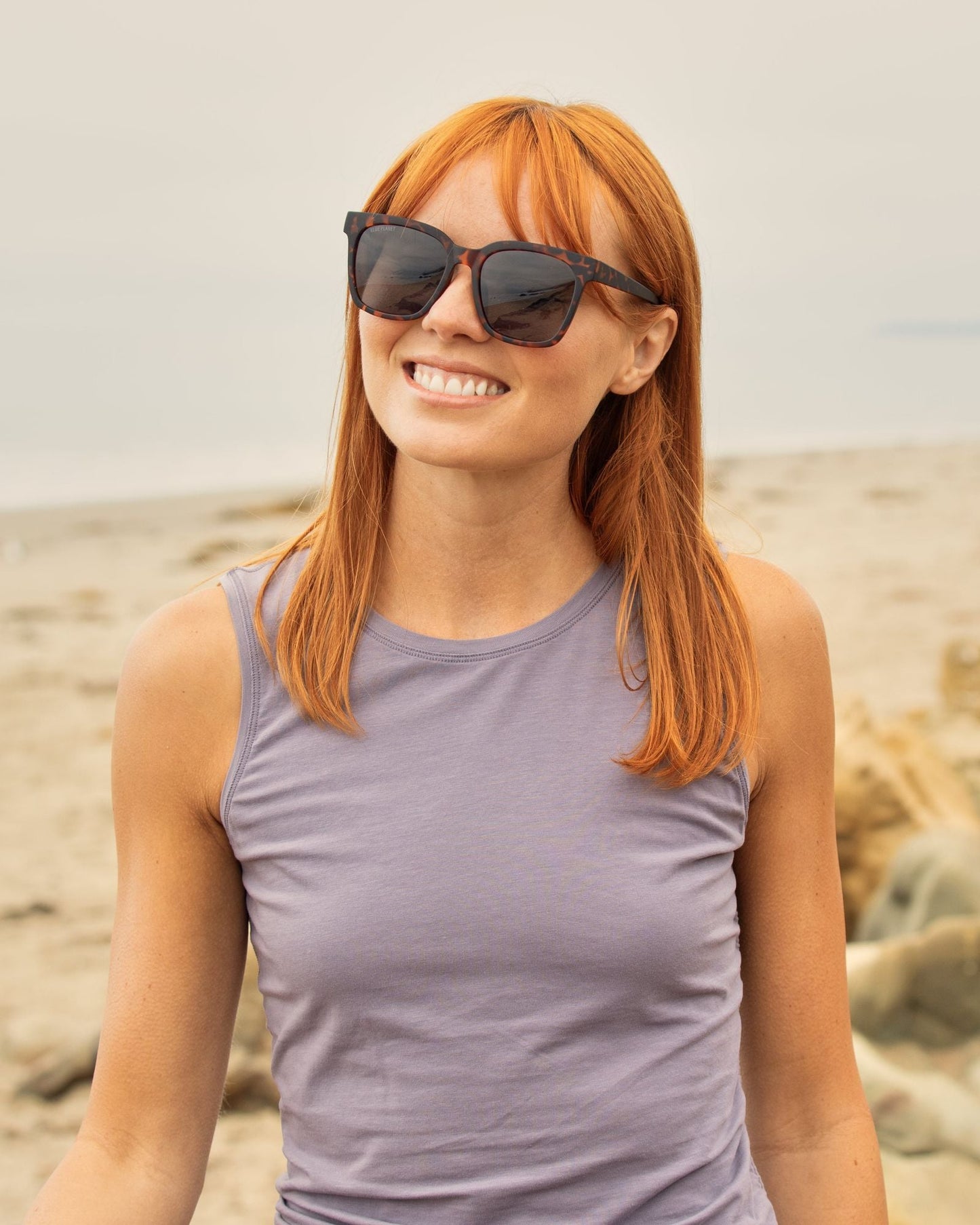 Polarized sunglasses with dark lenses and square tortoiseshell frames on a person