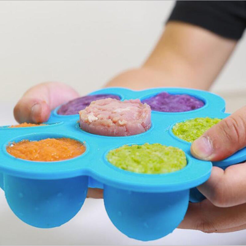 Blue silicone 7-cavity egg bite mold filled with small bites