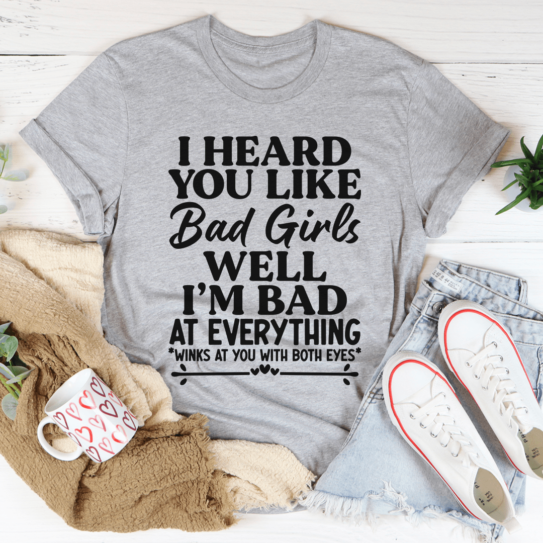 Dark heather gray crew-neck graphic T-shirt with centered 'Bad Girls' quote in white.