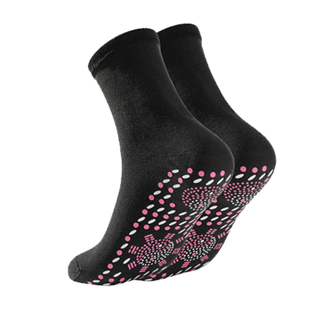 Pair of black self-heating health socks for women with pink dotted pattern on footbed