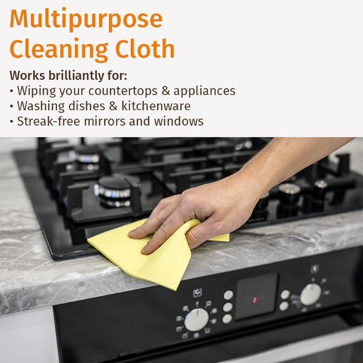 Hand wiping a stove with a yellow multi-surface cleaning cloth wipe