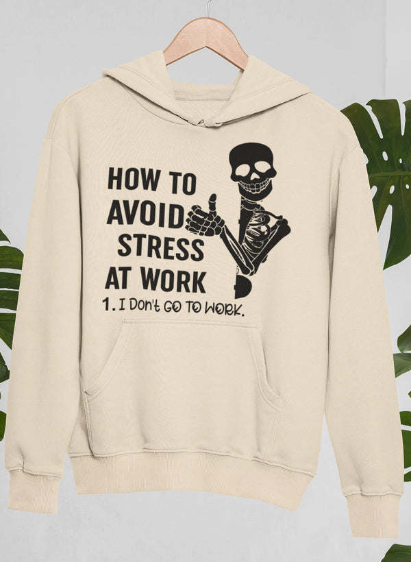 Cream hoodie with front pocket and skull hand graphic on chest
