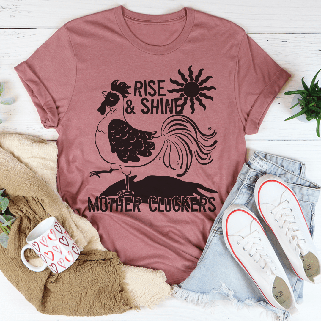 Mauve crewneck T-shirt with rooster graphic and 'Rise & Shine' text