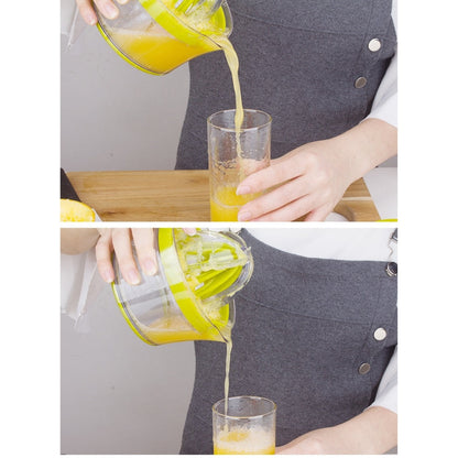 Green manual citrus squeezer pouring juice into a glass on a countertop.