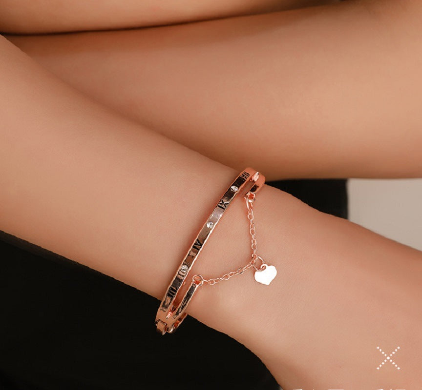 Rose gold stainless steel bracelet bangle with Roman numerals and small heart pendant