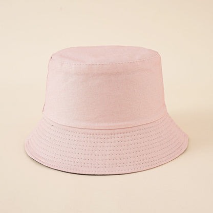 Pink fisherman bucket hat with perforated stitched band around the brim