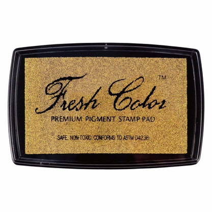 Gold pigment stamp pad in black case with 'Fresh Color' logo over speckled ink.