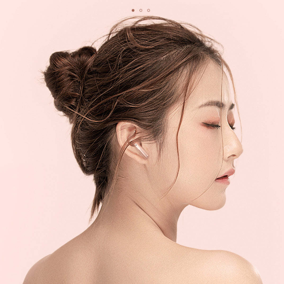 In-ear wireless earbud with metallic rose gold finish on a person’s ear