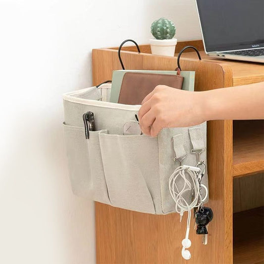 White hanging bedside storage bag with compartments and hanging key holder