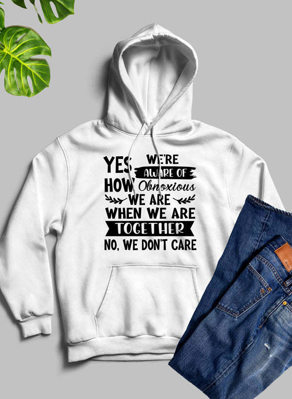 White pullover hoodie with hood and drawstrings, front slogan graphic text.