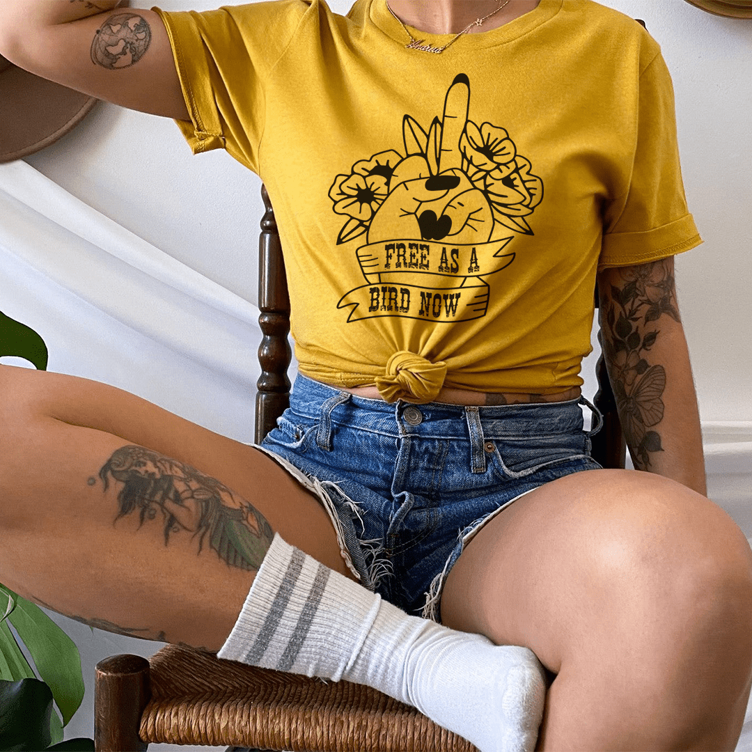 Mustard yellow crew-neck T-shirt with bird-and-cat floral graphic