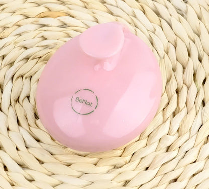 Pink rolling body massager disk with smooth silicone surface and molded grip