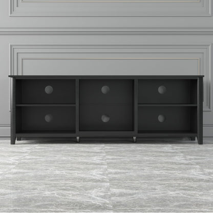 Black TV stand with six open shelf cubbies and drawers with round pulls across the front.