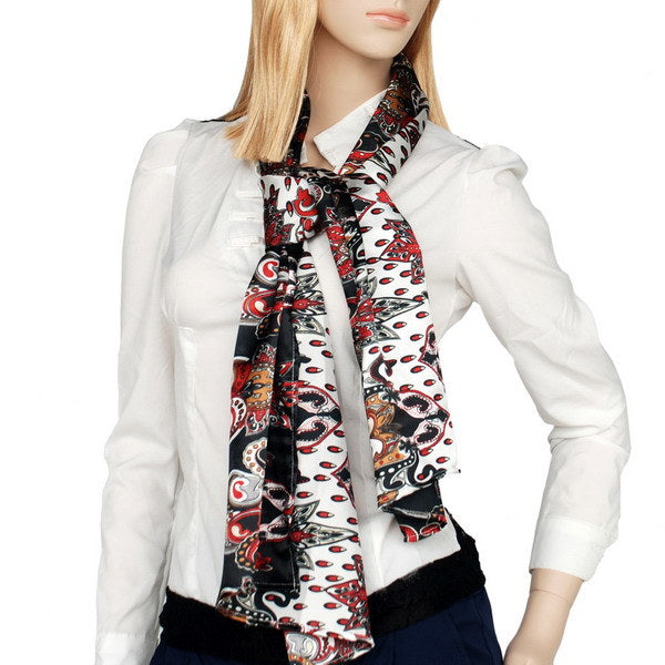 Paisley scarf wrap on model’s neck, black with red and white paisley pattern