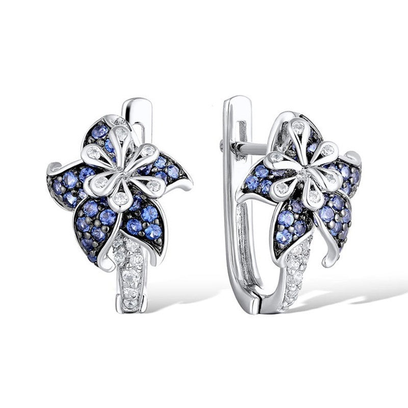 Silver-tone hoop-style earrings with blue flower clusters and clear zircon centers
