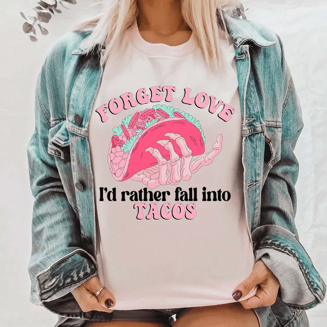 Cream T-shirt with colorful taco graphic and text 'I'd rather fall into Tacos'