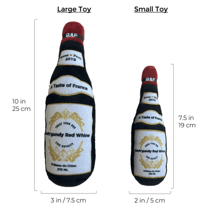 Wine bottle squeaky dog plush toy with size marks: 10in bottle and 2in bottle, red neck