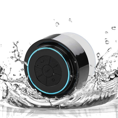 Waterproof Bluetooth speaker with black housing and blue LED ring around the controls