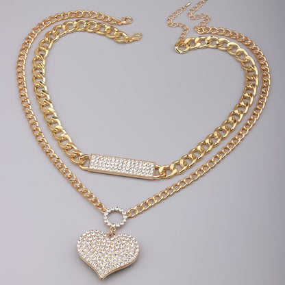 Gold double necklace set with crystal bar and heart pendant on layered chains