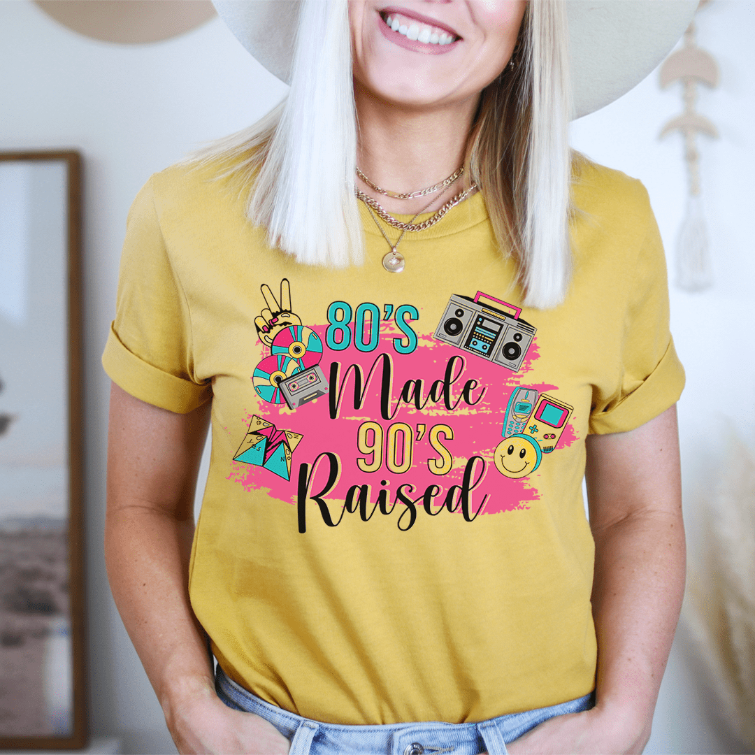 Mustard T-shirt with neon '80's Made 90's Raised' graphic front