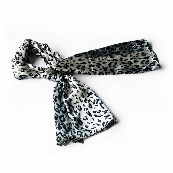 Small silk scarf with black leopard print on white, tied bow ends