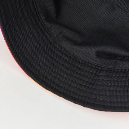 Black bucket hat brim close-up with ridged weave texture and stitched hem