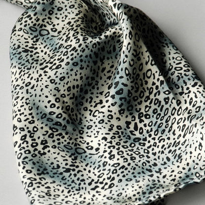 Leopard-pattern silk scarf fabric in light blue with black irregular spots