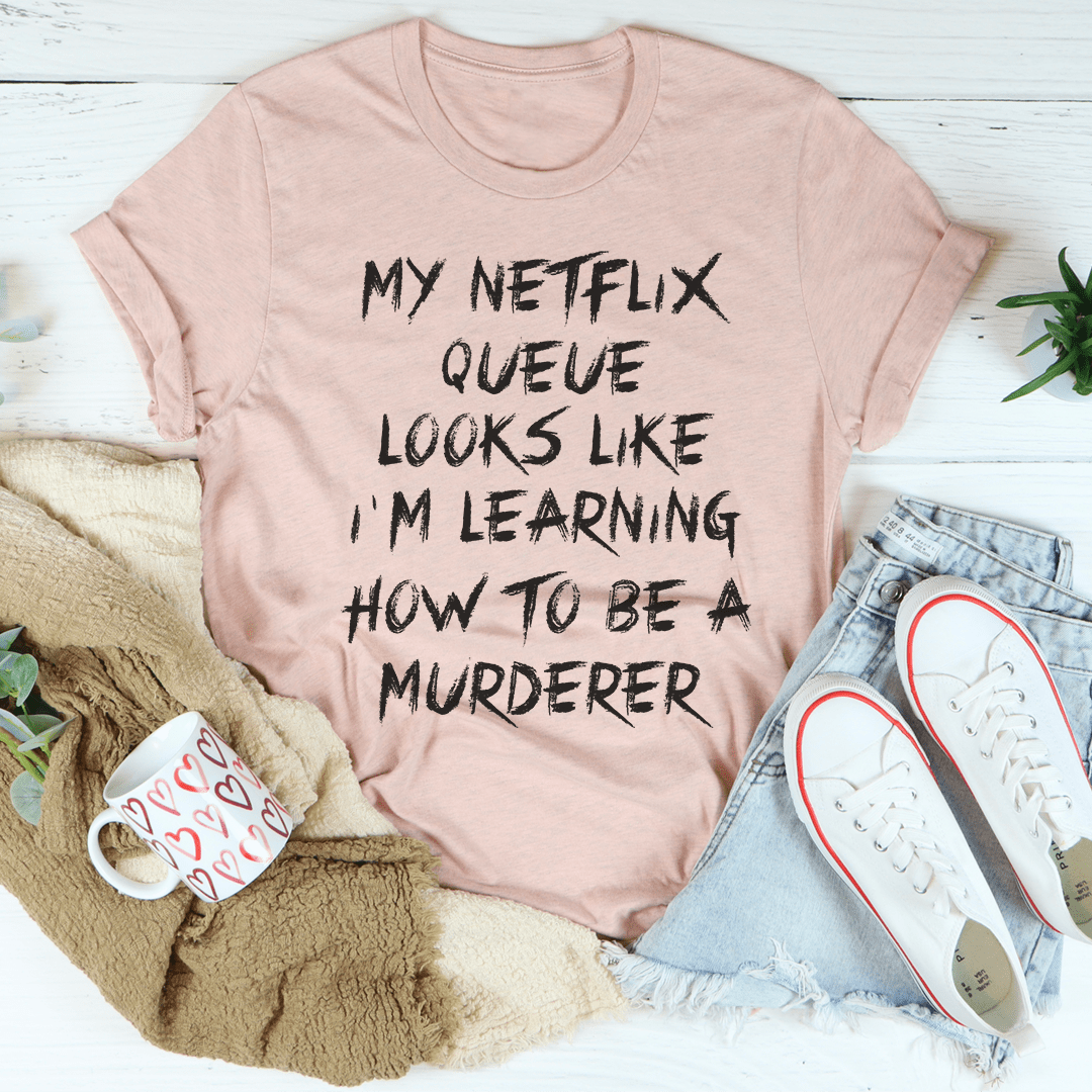 Peach T-shirt with dark 'My Netflix Queue' quote graphic