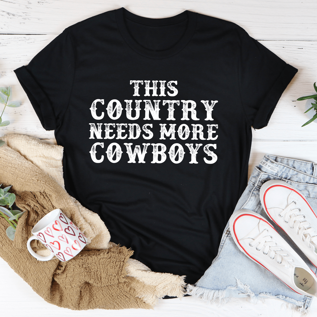 Black heather T-shirt with large white 'THIS COUNTRY NEEDS MORE COWBOYS' print