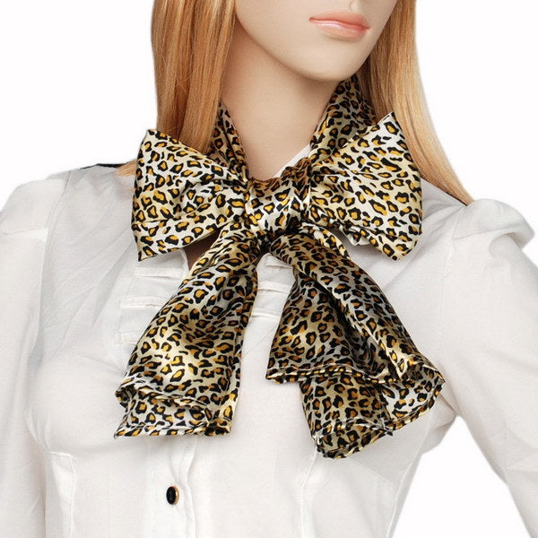 Leopard print silk scarf with layered bow at the neck; tan and dark brown