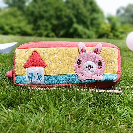 Embroidered pencil pouch with rabbit applique, yellow and teal panels, pink trim, zipper