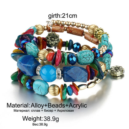 Boho multilayer charm bracelet with blue turquoise stones, red beads, and gold-tone charm