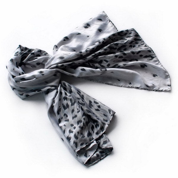 Silk scarf wrap in silver-gray with leopard spots, lightly draped