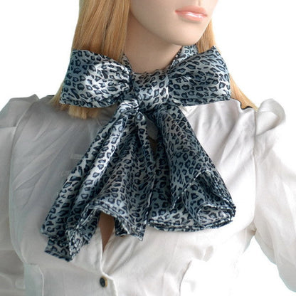Light blue leopard print scarf tied at neck with flowing ends