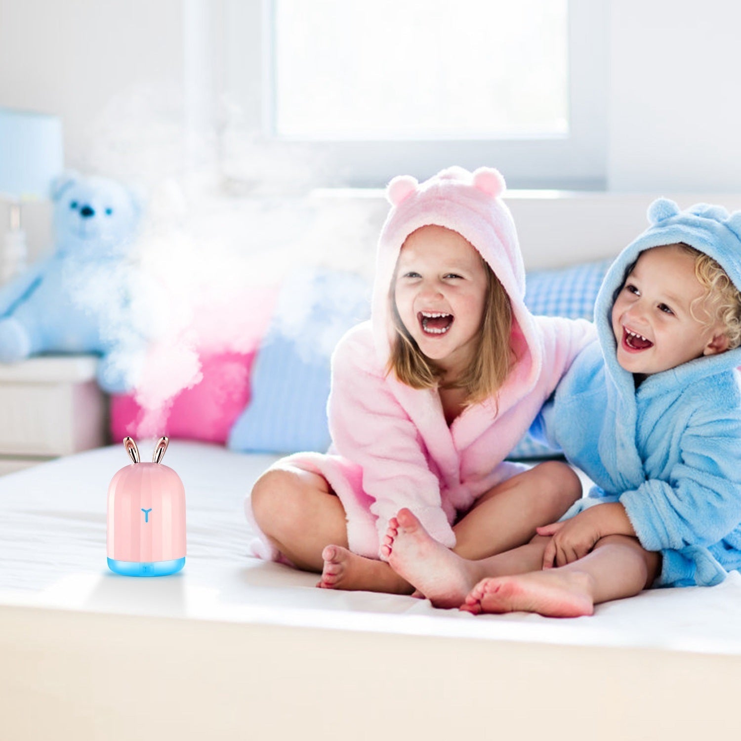 Pink bunny cool mist humidifier emitting mist with blue base light glow