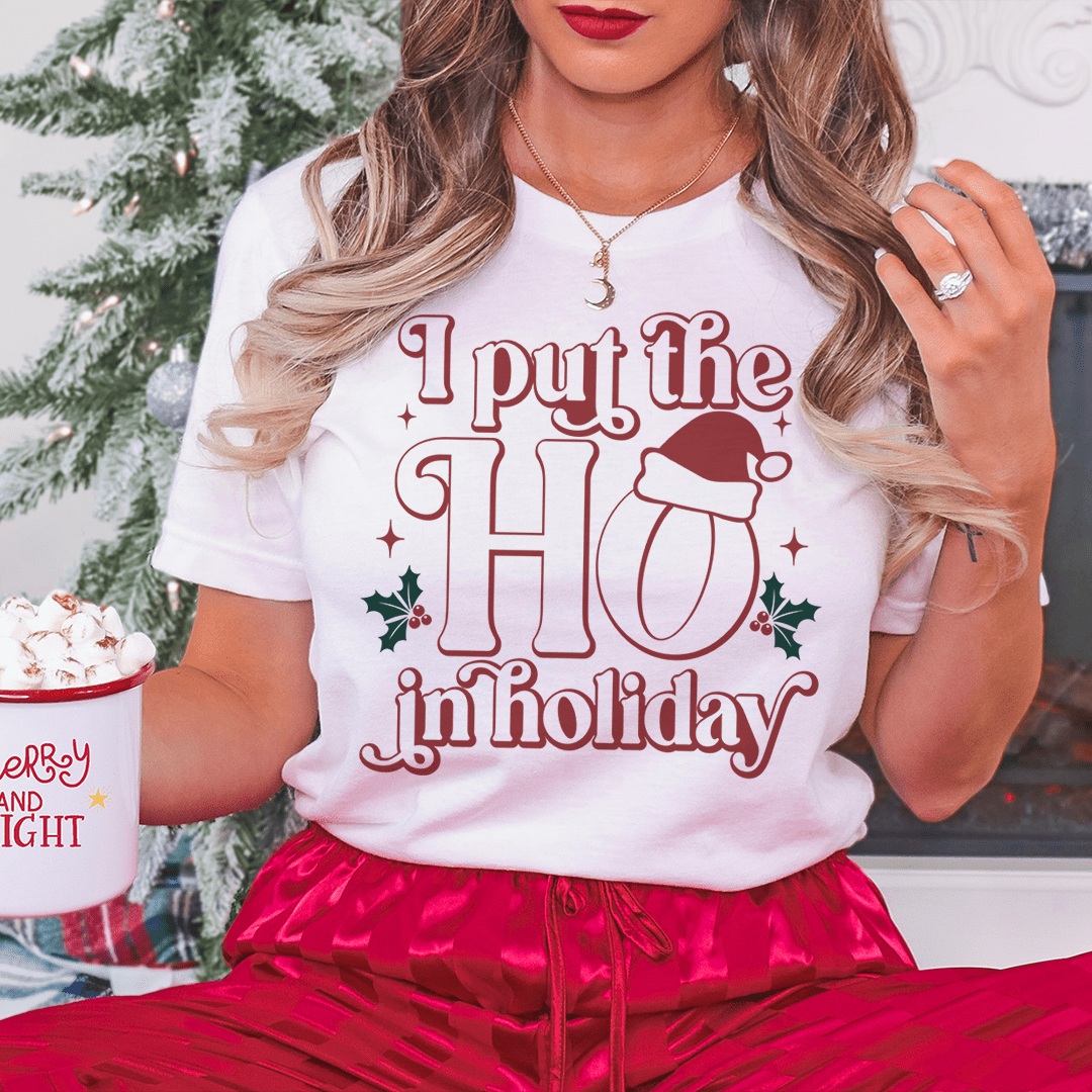 White crew-neck T-shirt with red holiday graphic text and hat icon