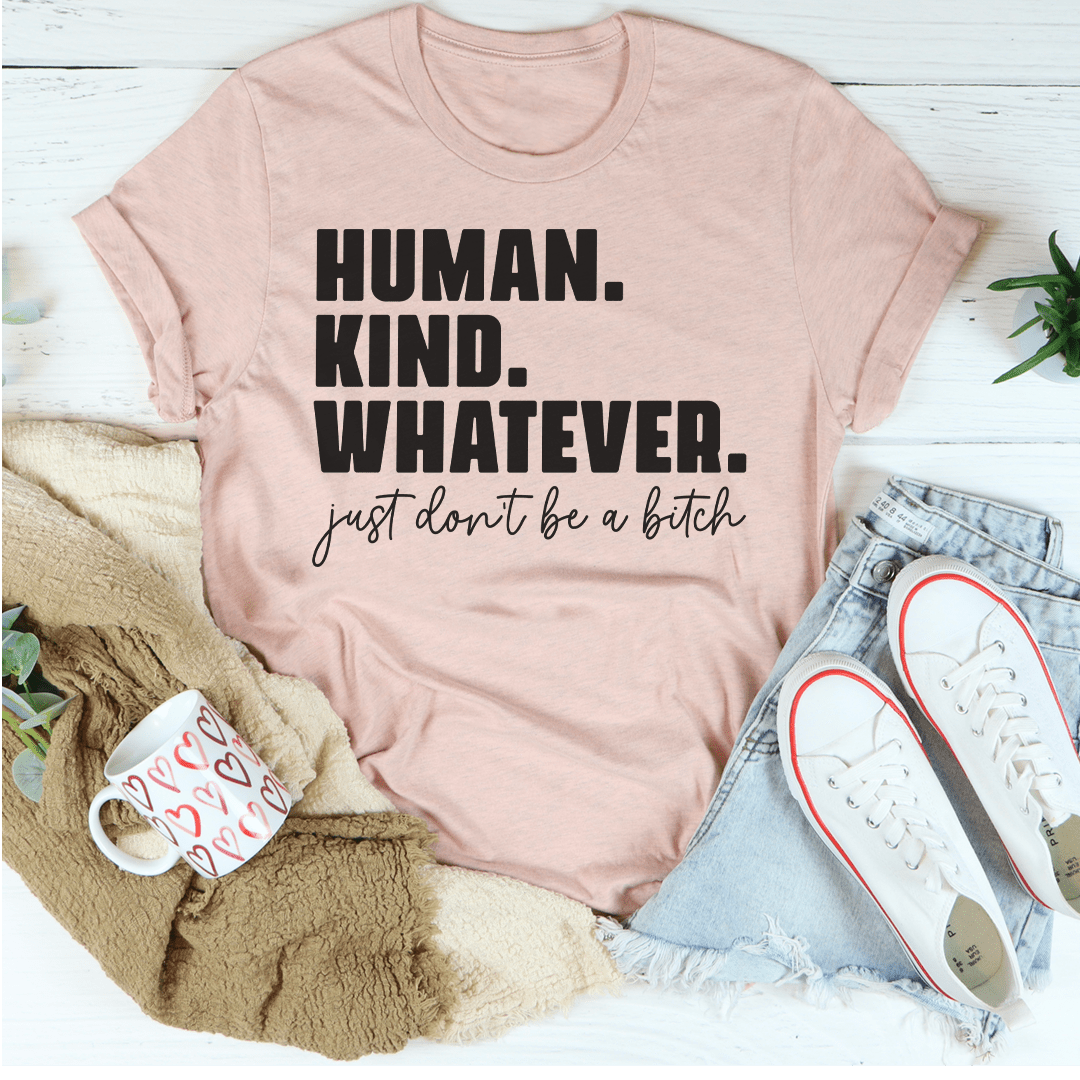 Soft pink graphic t-shirt with bold 'HUMAN. KIND. WHATEVER.' and cursive slogan